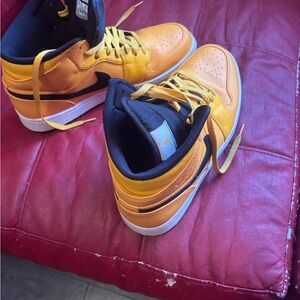 University gold and black Nike Air Jordan size 12.  Smoke free home.